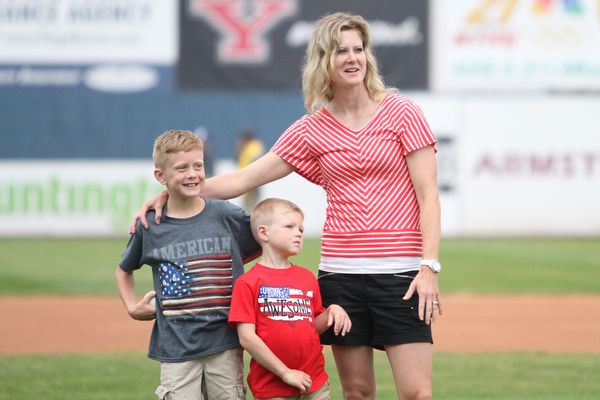 Nikos Frazier | The Vindicator..Carrie Seachrist(right) of Canfield, puts her arm around her sons Grant(left), 7 and Trevor, 4. Grant threw out on of the first pitches before the Scrappers took on the Lake Monsters.