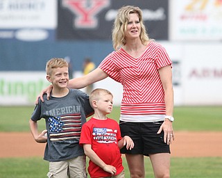 Nikos Frazier | The Vindicator..Carrie Seachrist(right) of Canfield, puts her arm around her sons Grant(left), 7 and Trevor, 4. Grant threw out on of the first pitches before the Scrappers took on the Lake Monsters.