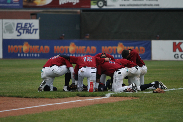 Nikos Frazier | The Vindicator..Scrappers kneel in silence before taking on the Vermont Lake Monsters on July 4, 2016.