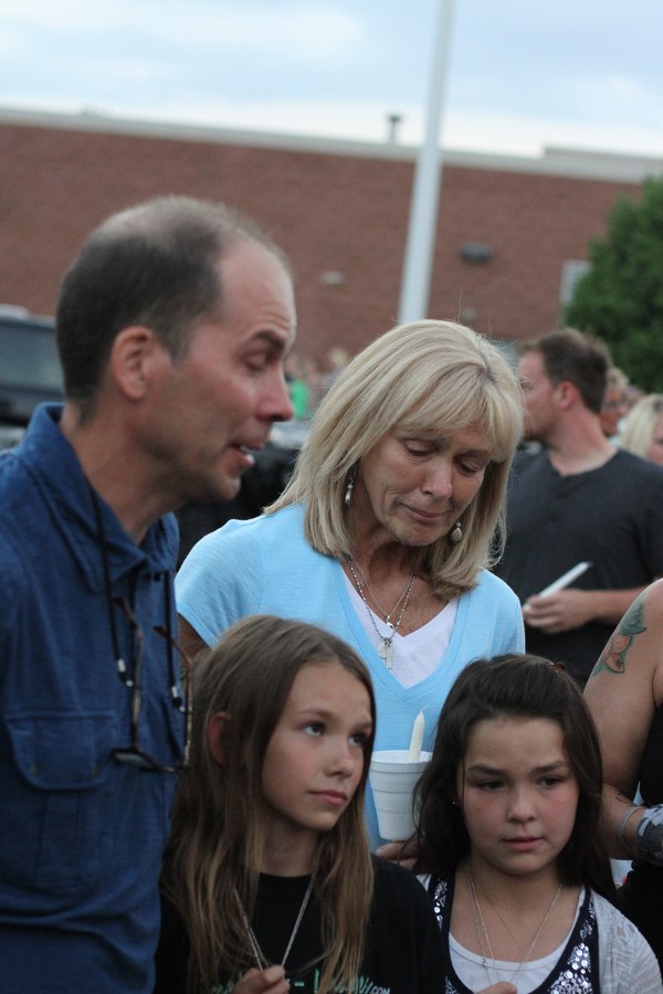 Nikos Frazier | The Vindicator..Janet Bartell(top right), mother to the late Kristy Wolfe Taafe, looks down as Jimmy Taafe, left, talks about his wife. Below his are his daughters, Mickayla, 10, and Gianna, 9.