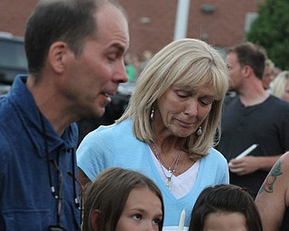 Nikos Frazier | The Vindicator..Janet Bartell(top right), mother to the late Kristy Wolfe Taafe, looks down as Jimmy Taafe, left, talks about his wife. Below his are his daughters, Mickayla, 10, and Gianna, 9.