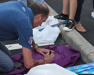 Nikos Frazier | The Vindicator..Jimmy Taafe writes a message on a Chinese lantern for his late wife, Kristy Wolfe Taafe.