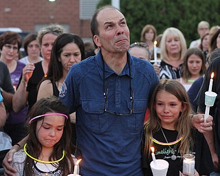 Nikos Frazier | The Vindicator..Jimmy Taafe(center) puts his arms around his daughters, Gianna(left), 9 and Mickayla(right), 10 at a candlelight vigil for his late wife, Kristy Wolfe Taafe, who died unexpectedly Sunday.