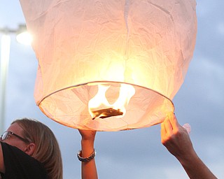 Nikos Frazier | The Vindicator..MicKayla Taafe, 10, holds a chinese lantern at a candlelight vigil for her mother, Kristy Wolfe Taafe, who died unexpectedly on Sunday.