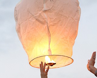 Nikos Frazier | The Vindicator..A Chinese lantern with messages for Kristy Wolfe Taafe is released at a candlelight vigil at Struthers Elementary School. Taafe died unexpectedly on Sunday.