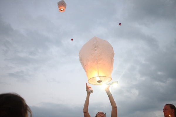 Nikos Frazier | The Vindicator..A woman releases a chinese lantern for Kristy Wolfe Taafe who died unexpectedly on Sunday.