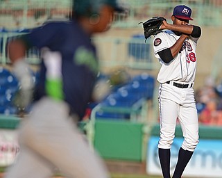 NILES, OHIO - JULY 5, 2016: Starting pitcher Luis Jimenez #38 of the Scrappers wipes his face off while Eric Marinez #2 of the Lake Monsters trots the bases after a solo home run in the second inning of Tuesday nights game at Eastwood Field. DAVID DERMER | THE VINDICATOR