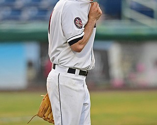 NILES, OHIO - JULY 5, 2016: Relief pitcher Dace Kime #51 of the Scrappers wipes his face off after a two RBI single by Sean Murphy #33 of the Lake Monsters in the sixth inning of Tuesday nights game at Eastwood Field. DAVID DERMER | THE VINDICATOR