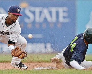 Jeff Lange | The Vindicator  WED, JUL 6, 2016 - Scrappers second baseman Erlin Cerda (left) misses the throw from home plate as Lakemonsters' base runner Steven Pallares (14) slides safely into the bag in the second inning of Wednesday's game at Eastwood Field.