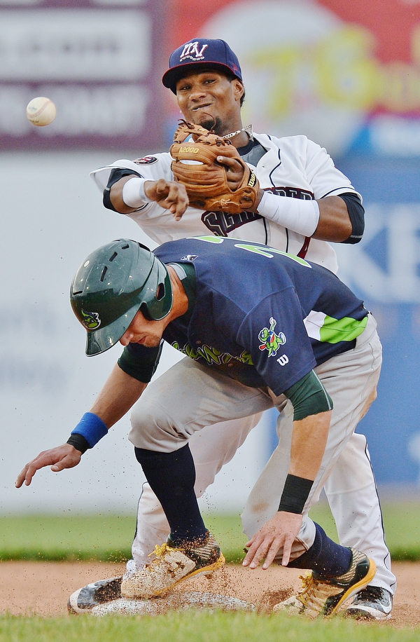 Jeff Lange | The Vindicator  WED, JUL 6, 2016 - Scrappers second baseman Erlin Cerda (top) turns a double play over Vermont base runner Eli White in the second inning of Wednesday's game at Eastwood Field.