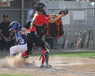 Nikos Frazier | The Vindicator..Poland's Camryn Latttanzio(12) slides into home in the Junior League district title game at the Field of Dreams in Boardman.
