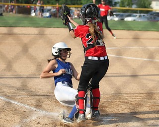 Nikos Frazier | The Vindicator.. Poland runner, Hannah Wolfe(5) slides into home as Canfield Catcher, Jenna Troxil(22) catches the ball to late in the Junior League district title game at the Field of Dreams in Boardman.