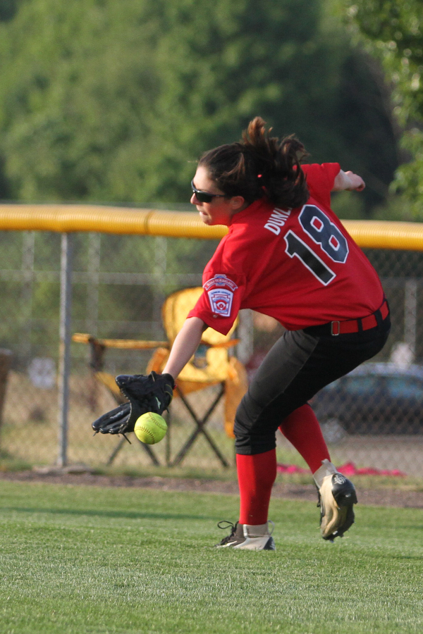 Nikos Frazier | The Vindicator..Canfield's Brianna Dunlap(18) misses a catch a ball in right field during the Junior League district title game at the Field of Dreams in Boardman.