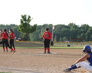 Nikos Frazier | The Vindicator..Poland's Lexi Diaz(11) sits on first base as Canfield warms up a new pitcher during the Junior League district title game at the Field of Dreams in Boardman.