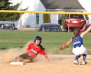 Nikos Frazier | The Vindicator.. Canfield Kaili Gross(17), slides into second as Poland's shortstop Lauren Sienkiewicz(17), catches the ball too late during the Junior League district title game at the Field of Dreams in Boardman.