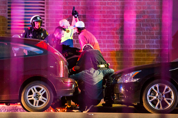 Dallas Police shield bystanders after shots were fired Thursday, July 7, 2016, during a protest over two recent fatal police shootings of black men. (Smiley N. Pool | The Dallas Morning News via AP)