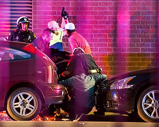 Dallas Police shield bystanders after shots were fired Thursday, July 7, 2016, during a protest over two recent fatal police shootings of black men. (Smiley N. Pool | The Dallas Morning News via AP)