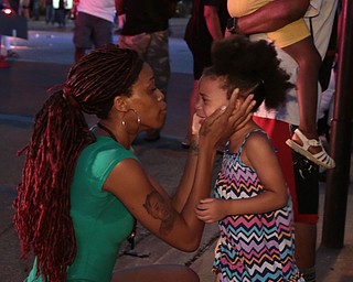 A mother tries to calm her daughter as Dallas police respond to shots being fired during a protest over recent fatal shootings by police in Louisiana and Minnesota,Thursday, July 7, 2016, in Dallas. Snipers opened fire on police officers during protests; several officers were killed, police said. (Maria R. Olivas | The Dallas Morning News via AP)