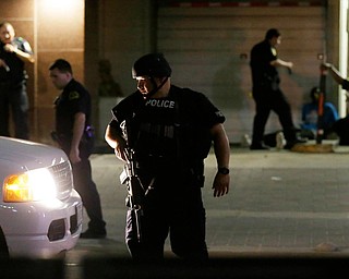 Dallas police detain a driver after several police officers were shot in downtown Dallas, Thursday, July 7, 2016. Snipers apparently shot police officers during protests and some of the officers are dead, the city's police chief said in a statement. (LM Otero | AP Photo)