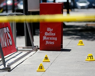 Evidence markers are seen in a plaza at the area of the attack on Dallas police officers last night in Dallas, Friday, July 8, 2016. A peaceful protest in Dallas over the recent videotaped shootings of black men by police turned violent Thursday night as an unknown number of people shot at officers, killing five and injuring seven, as well as two civilians. (Gerald Herbert | AP Photo)