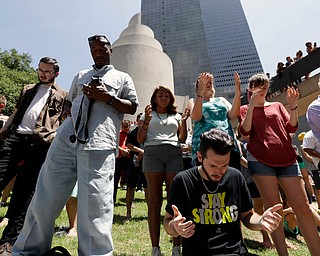 People take part in a prayer vigil at Thanksgiving Square, Friday, July 8, 2016, in Dallas. Five police officers are dead and several injured following a shooting during what began as a peaceful protest in the city the night before. (Eric Gay | AP Photo)