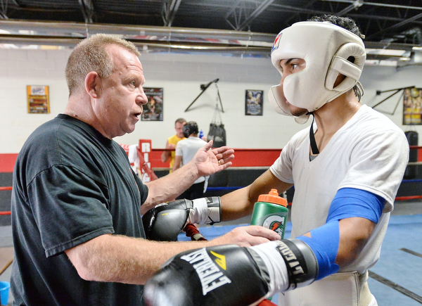 Jeff Lange | The Vindicator  SAT, JUL 9, 2016 - John Loew of South Side Boxing (left) coaches Popo Salinas in between rounds of a sparring match during training at the gym on Market Street on Saturday, July 9, 2016.
