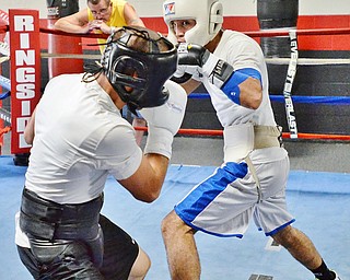 Jeff Lange | The Vindicator SAT, JUL 9, 2016 - Popo Salinas (right) looks to jab opponent Jake Giuriceo during a sparring match while training at the gym on Market Street on Saturday, July 9, 2016.