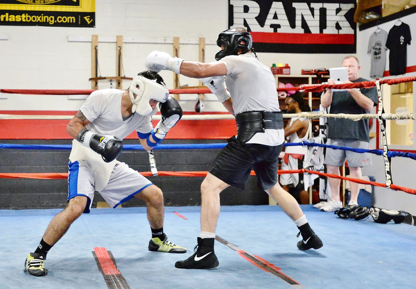 Jeff Lange | The Vindicator  SAT, JUL 9, 2016 -Popo Salinas ducks under Jake Giuriceo's punch during a sparring match while training at the gym on Market Street on Saturday, July 9, 2016.