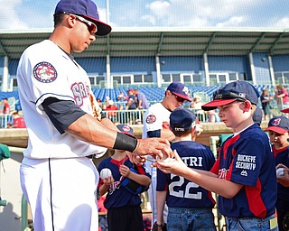NILES, OHIO - JULY 11, 2016: Michael Brantley #23 of the Scrappers hands a baseball back to Noah Fowler 9, of Wintersville, Ohio after autographing it for him before Monday nights game against the Tri-City ValleyCats at Eastwood Field. DAVID DERMER | THE VINDICATOR