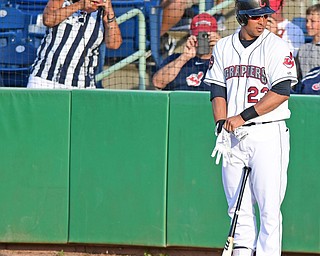 NILES, OHIO - JULY 11, 2016: Michael Brantley #23 of the Scrappers adjusts his batting gloves in the on deck circle while fans behind him snap pictures on their cell phones prior to his at bat in the first inning of Monday nights game against the Tri-City ValleyCats at Eastwood Field. DAVID DERMER | THE VINDICATOR
