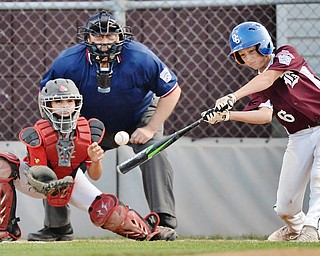 Jeff Lange | The Vindicator  MON, JUL 11, 2016 - Boardman's Sean O'Horo (6) takes a swing at a pitch as Canfield catcher Landon Beidelschies looks on in the top of the first inning of Monday's game against Canfield at Field of Dreams in Boardman.