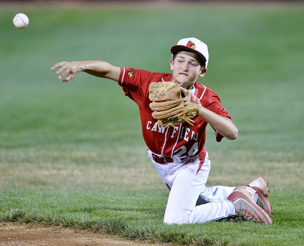 Jeff Lange | The Vindicator  MON, JUL 11, 2016 - Canfield second baseman Drew Carrocce makes a throw to first from his knees after fielding a ground ball sent up the middle in the top of the second inning of Monday's game against Boardman at Field of Dreams in Boardman.