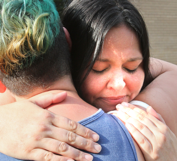 William D. Lewis/The Vindicator  Shannon Pappas, facing camera, mother of Maddison Papas a Fitch student who recently died, gets a hug from Fitch student Drew Rodriguez during a Monday July 11,2016 vigil at Fitch HS.