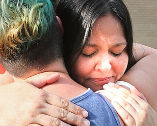 William D. Lewis/The Vindicator  Shannon Pappas, facing camera, mother of Maddison Papas a Fitch student who recently died, gets a hug from Fitch student Drew Rodriguez during a Monday July 11,2016 vigil at Fitch HS.