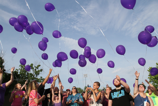 William D. Lewis/The Vindicator  Friends and family of Maddison Pappas, a Fitch HS student who recently died, launch balloons during a July 11,2016 vigil at Fitch HS.