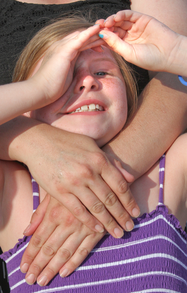 William D Lewis/The Vindicator  Ava Pappas, 8, sister of Maddison Pappas, a Fitch HS student who recently died, looks aloft at balloons launched during a July 11,2016 vigil at Fitch HS.