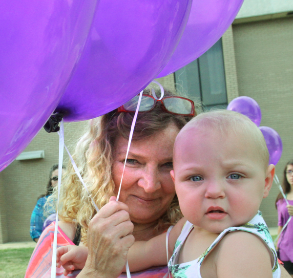 William D. Lewis/The Vindicator Renee Gregory of Austintown and grandmother of Maddison Pappas who recently died holds another of her grandchildren Hailey Gregory, 1, during a July 11, 2016 vigil for MAdison at fitch HS.