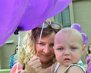 William D. Lewis/The Vindicator Renee Gregory of Austintown and grandmother of Maddison Pappas who recently died holds another of her grandchildren Hailey Gregory, 1, during a July 11, 2016 vigil for MAdison at fitch HS.