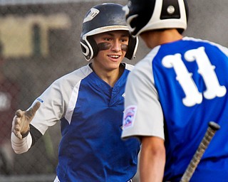 William D. Lewis /The Vindicator  Poland's Jake Bacon (8) gets congrats from Stephen Carney(11) after hitting a 4th inning in the park home run during July 13, 2016 game with Boardman at Field of Dreams.