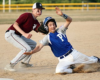 William D. Lewis/The Vindicator Poland's Jarret Shurilla(48) is tagged out at third by Boardman's Mason Smith(22) during July 13, 2016 gme at Field of Dreams.
