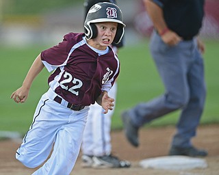 BOARDMAN, OHIO - JULY 15, 2016: Caleb Satterfield(22) of Boardman rounds third base to head home and score after a RBI single by Ryan Conti(20) in the first inning of Friday evenings District 2 9/10 year old Little League Championship game at the Field of Dreams. Boardman would go on to win 18-5. DAVID DERMER | THE VINDICATOR
