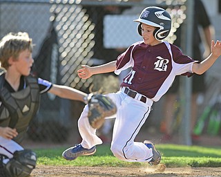 BOARD MAN, OHIO - JULY 15, 2016: Evan Sweder(11) of Boardman slides into home plate to score a run while beating the tag from catcher Nicky Beistel(41) of Canfield in the second inning of Friday evenings District 2 9/10 year old Little League Championship game at the Field of Dreams. Boardman would go on to win 18-5. DAVID DERMER | THE VINDICATOR