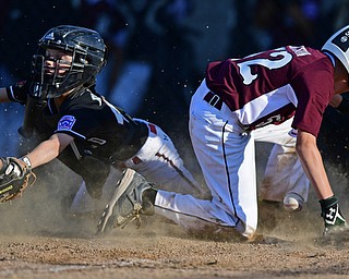 BOARD MAN, OHIO - JULY 15, 2016: Jack Ericson(52) of Boardman slides across home plate to score a run while catcher Nicky Beistel(41) of Canfield dives unsuccessfully t in an attempt to prevent a run in the second inning of Friday evenings District 2 9/10 year old Little League Championship game at the Field of Dreams. Boardman would go on to win 18-5. DAVID DERMER | THE VINDICATOR