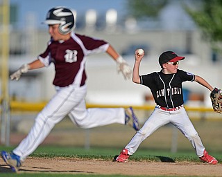 BOARD MAN, OHIO - JULY 15, 2016: Second baseman Jake Walker(8) of Canfield throws towards first for the out while base runner Dylan Barrett(23) of Boardman runs to second in the third inning of Friday evenings District 2 9/10 year old Little League Championship game at the Field of Dreams. Boardman would go on to win 18-5. DAVID DERMER | THE VINDICATOR