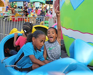 Melina Evans (5) of Arizona and Tyler McPherson (7) of Warren ride on the bunny rabbits during the Our Lady of Mount Carmel Festival in Niles on Sunday evening.  Dustin Livesay  |  The Vindicator  7/17/16  Niles.