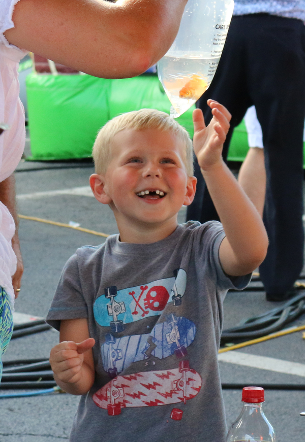 Matthew Modarelli (4) of Niles smiles while looking at the new fish he just won during the Our Lady of Mount Carmel Festival in Niles on Sunday evening.  Dustin Livesay  |  The Vindicator  7/17/16  Niles.