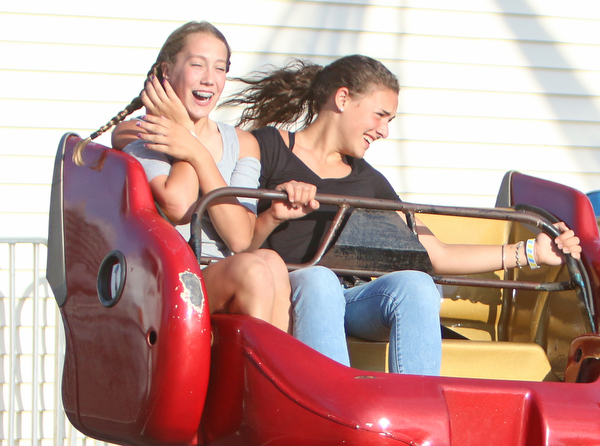  (L-R) Sophie Griffith (13) and her friend Seyhan Dede (13) both of Girard scream while riding on the sizzler during the Our Lady of Mount Carmel Festival in Niles on Sunday evening.  Dustin Livesay  |  The Vindicator  7/17/16  Niles.