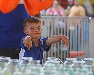 Rayden Iamurri (4) of Poland throws ping pong balls into fishbowls to win a prize during the Our Lady of Mount Carmel Festival in Niles on Sunday evening.  Dustin Livesay  |  The Vindicator  7/17/16  Niles.