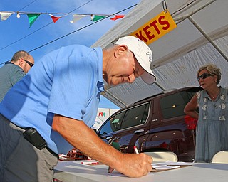 Louis Yacucci of North Jackson fills out a raffle ticket to win one of three grand prizes during the Our Lady of Mount Carmel Festival in Niles on Sunday evening.  Dustin Livesay  |  The Vindicator  7/17/16  Niles.