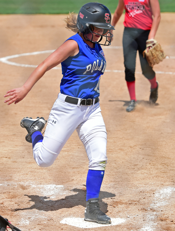 BOARDMAN, OHIO - JULY 18, 2016: Carley Francis #00 of Poland steps on home plate to score a run after wild pitch in the second inning of Monday afternoons Little League Championship game at Field of Dreams. Poland won 12-2. DAVID DERMER | THE VINDICATOR